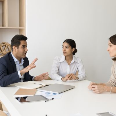 Engaged,Serious,Indian,Business,Leader,Man,Talking,To,Diverse,Colleagues